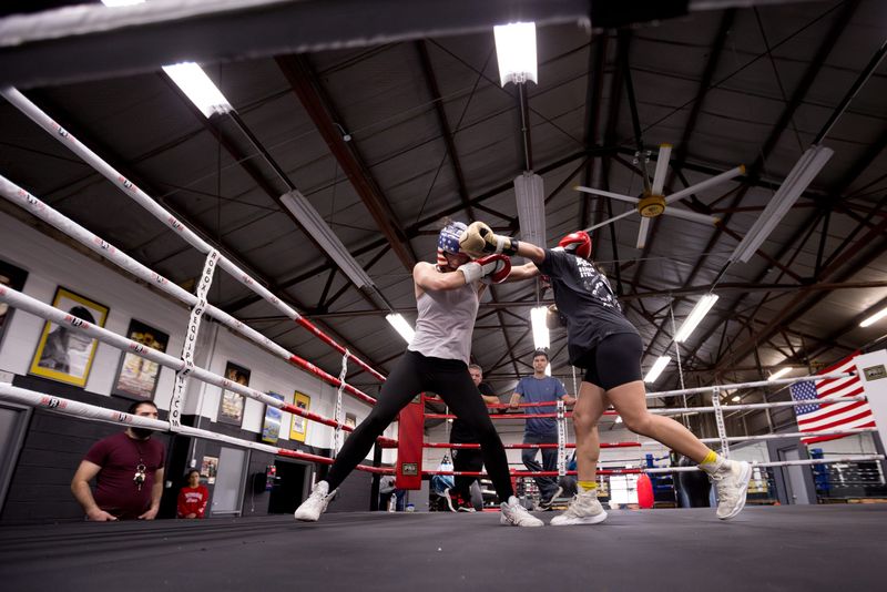 El Paso boxer Stephanie Han’s brothers, Izzy and Abie, and trainer Louie Burke watch as she spars with Las Cruces boxer Samantha Ginithan at the PAL Boxing Club in Las Cruces, New Mexico, on Friday, Dec. 12, 2025.