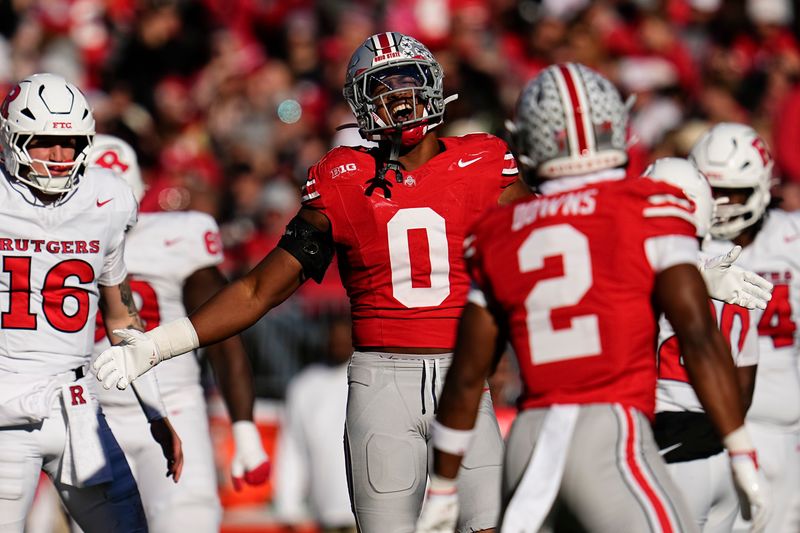 Ohio State Buckeyes linebacker Sonny Styles (0) celebrates a sack by defensive back Caleb Downs (2) during the second half of the NCAA football game at Ohio Stadium in Columbus on Nov. 22, 2025. Ohio State won 42-9.