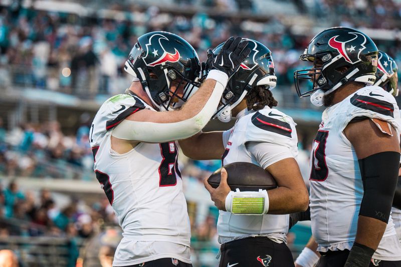 Dec 1, 2024; Jacksonville, Florida, USA; Houston Texans tight end Dalton Schultz (86) and quarterback C.J. Stroud (7) celebrate a touchdown in the fourth quarter at EverBank Stadium. Mandatory Credit: Jeremy Reper-Imagn Images