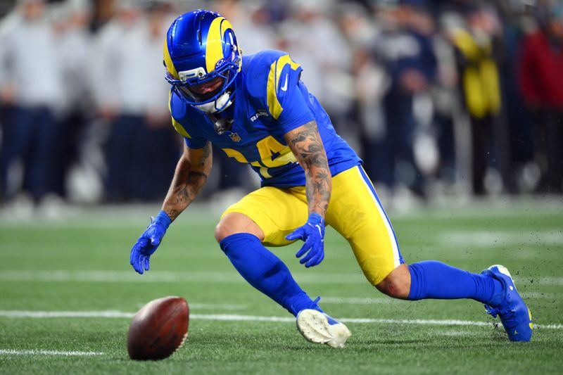 Dec 18, 2025; Seattle, Washington, USA; Los Angeles Rams cornerback Cobie Durant (14) recovers a fumble against the Seattle Seahawks in the first half at Lumen Field. Mandatory Credit: Steven Bisig-Imagn Images