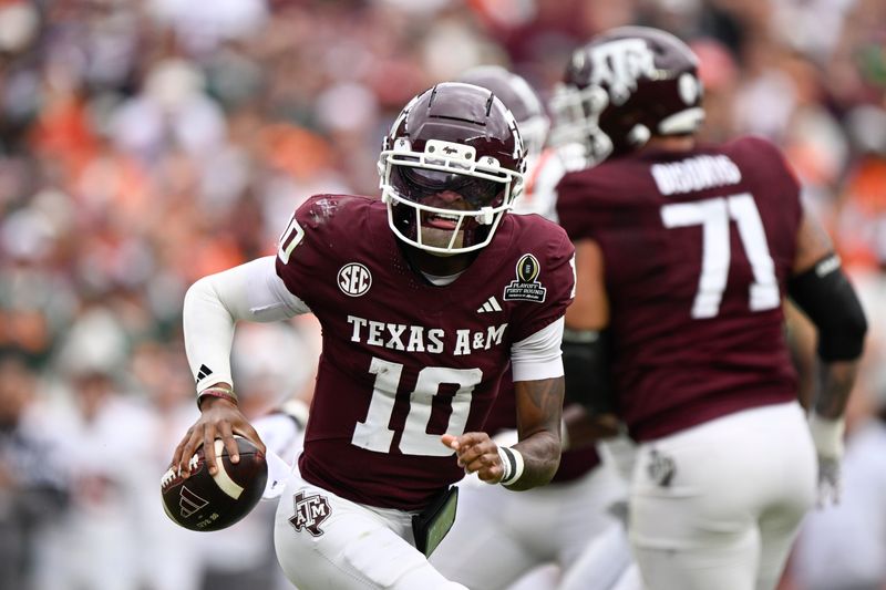 Dec 20, 2025; College Station, TX, USA; Texas A&M Aggies quarterback Marcel Reed (10) runs the ball against the Miami Hurricanes during first half of the first round game of the CFP National Playoff at Kyle Field. Mandatory Credit: Jerome Miron-Imagn Images