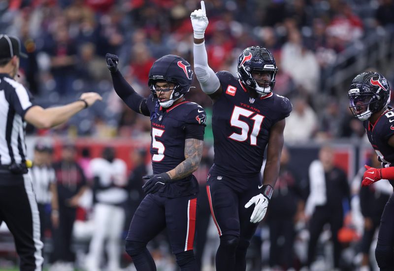 Dec 14, 2025; Houston, Texas, USA; Houston Texans safety Jalen Pitre (5) and defensive end Will Anderson Jr. (51) react after a defensive play during the first half against the Arizona Cardinals at NRG Stadium. Mandatory Credit: Troy Taormina-Imagn Images