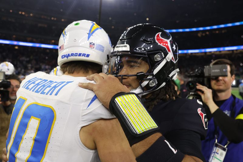Houston Texans quarterback C.J. Stroud (7) and LA Chargers quarterback Justin Herbert (10) meet after the AFC Wild Card game at NRG Stadium in Houston, Texas.