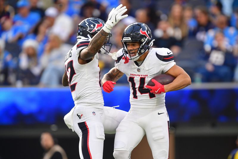 Dec 27, 2025; Inglewood, California, USA; Houston Texans wide receiver Jaylin Noel (14) reacts with wide receiver Nico Collins (12) after catching a touchdown against the Los Angeles Chargers during the first half at SoFi Stadium. Mandatory Credit: Gary A. Vasquez-Imagn Images