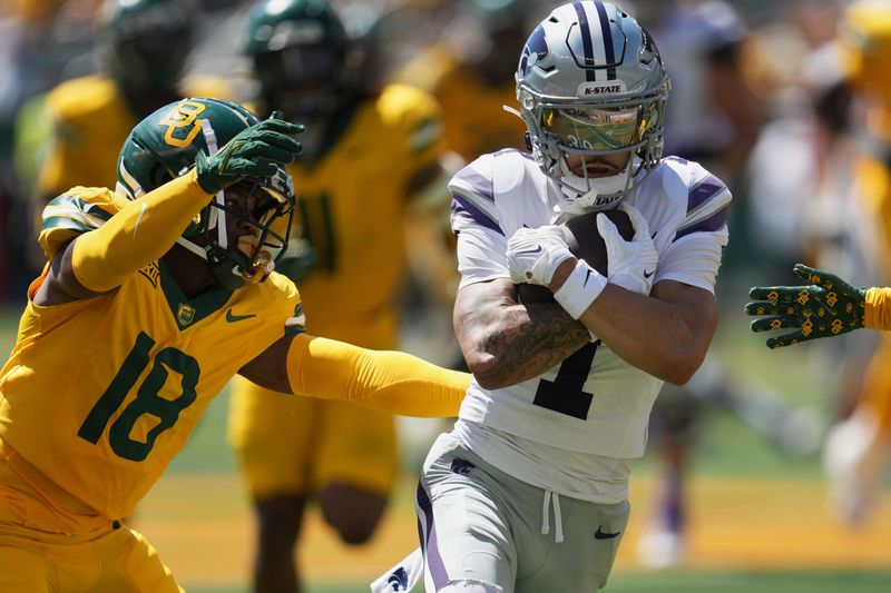Oct 4, 2025; Waco, Texas, USA; Kansas State Wildcats wide receiver Jayce Brown (1) protects the ball against Baylor Bears cornerback Caldra Williford (18) during the second half at McLane Stadium. Mandatory Credit: Chris Jones-Imagn Images