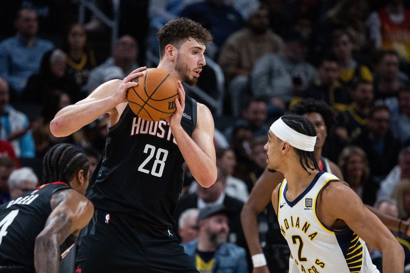 Mar 4, 2025; Indianapolis, Indiana, USA; Houston Rockets center Alperen Sengun (28) holds the ball while Indiana Pacers guard Andrew Nembhard (2) defends in the second half at Gainbridge Fieldhouse. Mandatory Credit: Trevor Ruszkowski-Imagn Images
