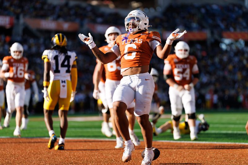 Dec 31, 2025; Orlando, FL, USA; Texas Longhorns running back Christian Clark (6) gestures after scoring a touchdown against the Michigan Wolverines during the first half at Camping World Stadium. Mandatory Credit: Matt Pendleton-Imagn Images