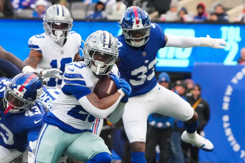 Jan 4, 2026; East Rutherford, New Jersey, USA; Dallas Cowboys running back Jaydon Blue (23) rushes during the first quarter against the New York Giants at MetLife Stadium. Mandatory Credit: Robert Deutsch-Imagn Images