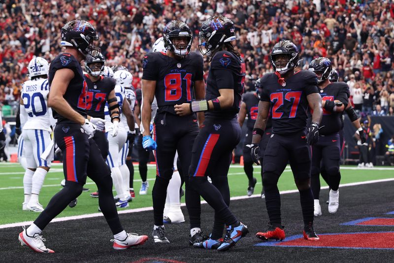 Jan 4, 2026; Houston, Texas, USA; Houston Texans quarterback C.J. Stroud (7) reacts with wide receiver Jayden Higgins (81) after a touchdown runs against the Indianapolis Colts during the first half at NRG Stadium. Mandatory Credit: Troy Taormina-Imagn Images