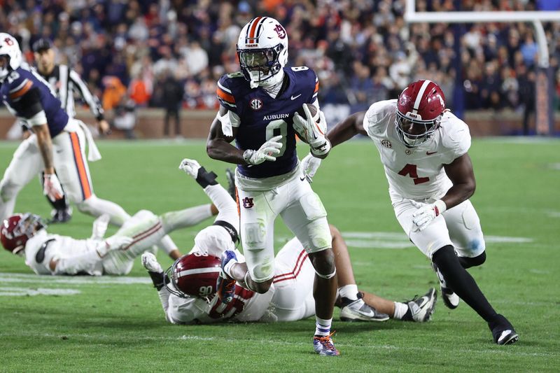 Nov 29, 2025; Auburn, Alabama, USA; Auburn Tigers wide receiver Cam Coleman (8) carries the ball during the second half against the Alabama Crimson Tide at Jordan-Hare Stadium. Mandatory Credit: John Reed-Imagn Images