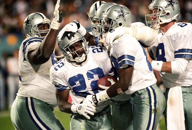 Jan 28, 1996; Tempe, AZ, USA; FILE PHOTO; Dallas Cowboys running back Emmitt Smith (22) is congratulated by teammates Nate Newton (61), Michael Irvin (88) and Troy Aikman (8) during Super Bowl XXX at Sun Devil Stadium. Mandatory Credit: Rob Schumacher/The Arizona Republic-USA TODAY Sports