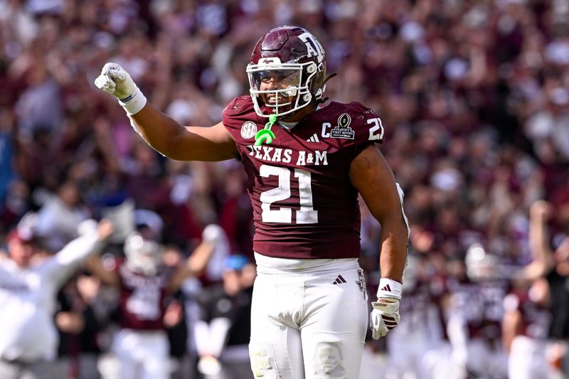 Dec 20, 2025; College Station, TX, USA; Texas A&M Aggies linebacker Taurean York (21) celebrates during the game between the Aggies and the Hurricanes at Kyle Field. Mandatory Credit: Jerome Miron-Imagn Images