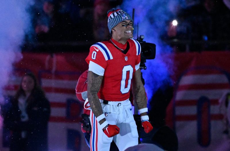 Dec 1, 2025; Foxborough, Massachusetts, USA; New England Patriots cornerback Christian Gonzalez (0) runs onto the field prior to the game against the New York Giants at Gillette Stadium. Mandatory Credit: Eric Canha-Imagn Images