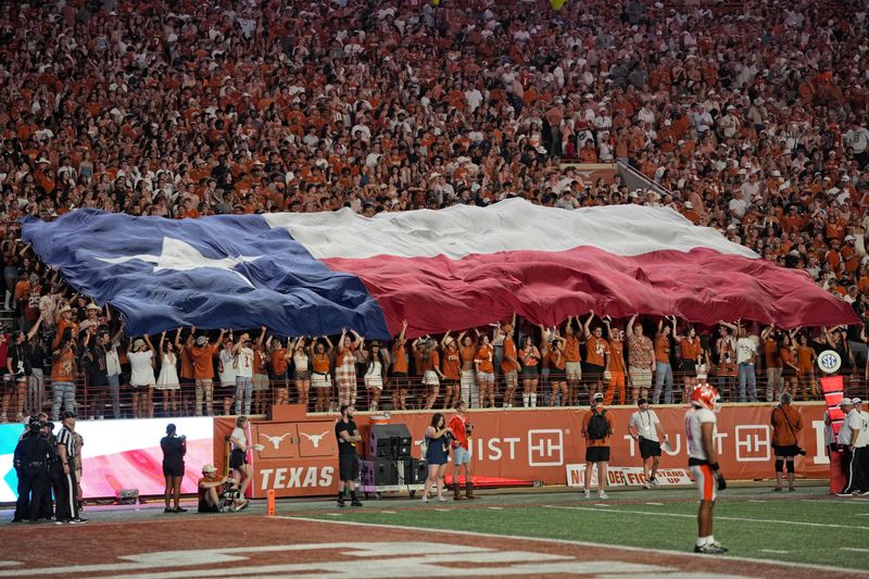 Sep 20, 2025; Austin, Texas, USA; Texas Longhorns fans hold the Texas state flag during a timeout in the first half against the Sam Houston Bearkats at Darrell K Royal-Texas Memorial Stadium. Mandatory Credit: Scott Wachter-Imagn Images