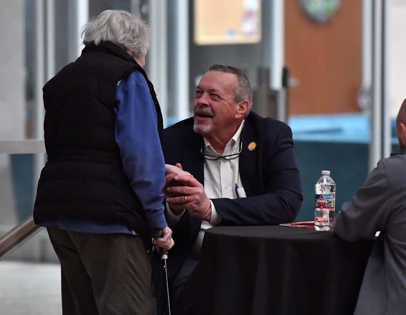 Jeff Watts greets a constituent at a candidate forum on Jan. 22.