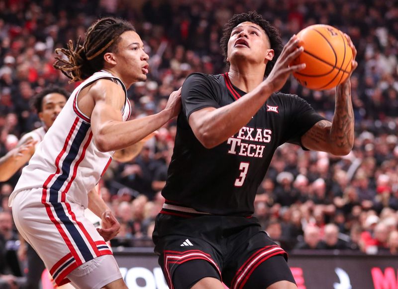 Texas Tech's LeJuan Watts is defended by Houston's Kingston Flemings during a Big 12 Conference men's basketball game, Saturday, Jan. 24, 2026, in United Supermarkets Arena.