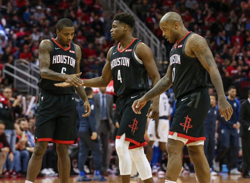Nov 28, 2018; Houston, TX, USA; Houston Rockets forward Danuel House Jr. (4) shakes hands with forward Gary Clark (6) as forward PJ Tucker (17) looks on during the fourth quarter against the Dallas Mavericks at Toyota Center. Mandatory Credit: Troy Taormina-USA TODAY Sports