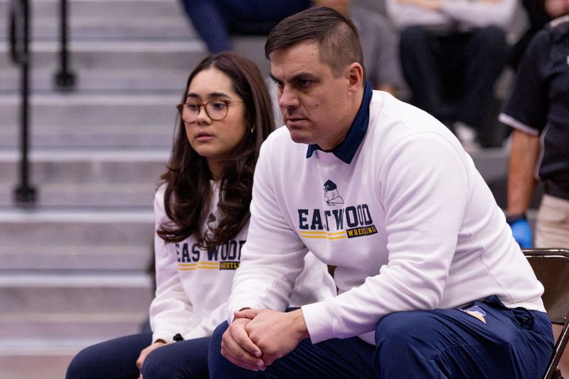Eastwood girls wrestling assistant coach Gabriela Castro and head coach Troy Douglas watch as Nayeli Ortiz wrestles Montwood’s Brooklyn Rodriguez in the 120-pound championship match during the District 1-6A wrestling tournament at Franklin High School in West El Paso, Texas, on Thursday, Jan. 29, 2026.