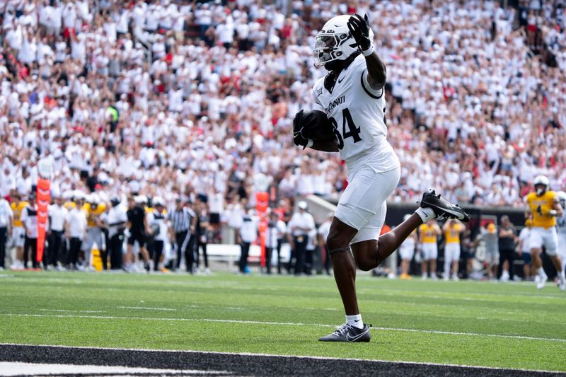 Cincinnati Bearcats wide receiver Sterling Berkhalter (84) gestures as he scores a touchdown in the first quarter of the College Football game between the Cincinnati Bearcats and the Towson Tigers at Nippert Stadium in Cincinnati on Saturday, Aug. 31, 2024.