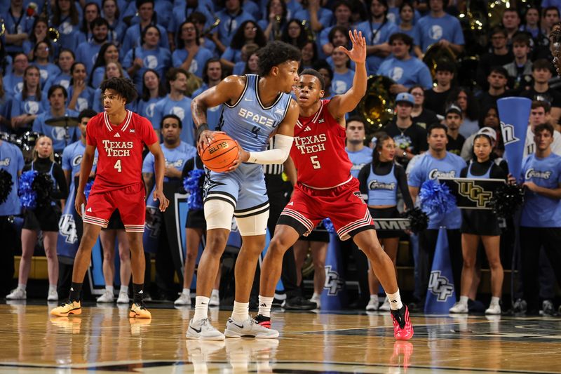 Jan 31, 2026; Orlando, Florida, USA; Texas Tech Red Raiders forward Josiah Moseley (5) defends UCF Knights forward Jamichael Stillwell (4) during the first half at Addition Financial Arena. Mandatory Credit: Mike Watters-Imagn Images