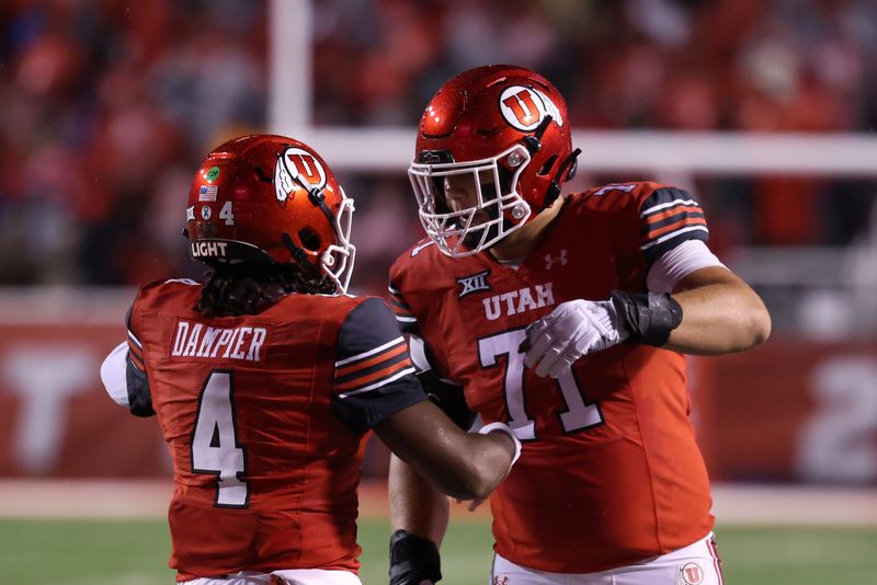 Oct 11, 2025; Salt Lake City, Utah, USA; Utah Utes quarterback Devon Dampier (4) celebrates scoring a touchdown against the Arizona State Sun Devils with Utah Utes offensive lineman Caleb Lomu (71) during the second quarter at Rice-Eccles Stadium. Mandatory Credit: Rob Gray-Imagn Images