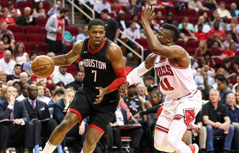 Mar 27, 2018; Houston, TX, USA; Houston Rockets guard Joe Johnson (7) dribbles the ball as Chicago Bulls forward David Nwaba (11) defends during the third quarter at Toyota Center. Mandatory Credit: Troy Taormina-USA TODAY Sports