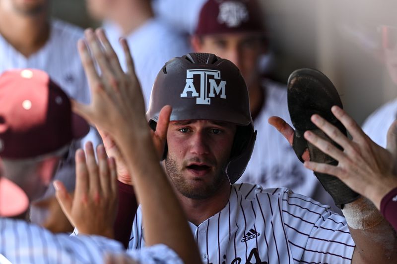 Jun 8, 2024; College Station, TX, USA; Texas A&M utility Gavin Grahovac (9) receives high fives in the dugout during the first inning against the Oregon at Olsen Field, Blue Bell Park Mandatory Credit: Maria Lysaker-USA TODAY Sports