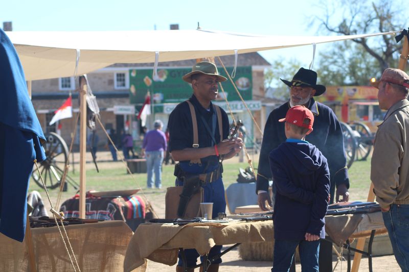 Buffalo Soldier reenactors talk with patrons at Christmas at Old Fort Concho in December 2025.