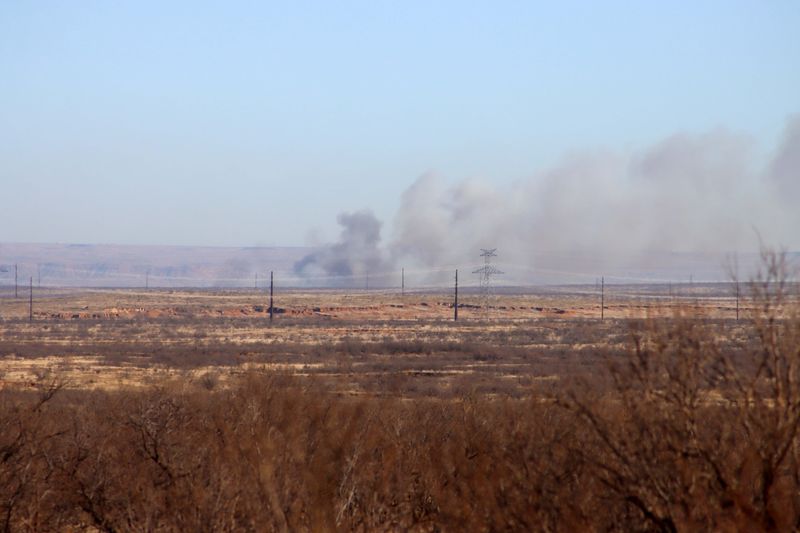 Smoke is seen in the distance Feb. 18 from the mandatory road block at the intersection of FM1061 and FM2381 west of Amarillo.