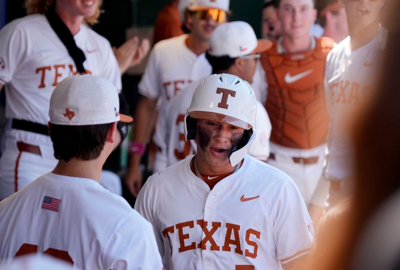 May 22, 2025; Hoover, AL, USA; Texas infielder Ethan Mendoza (5) is greeted in the dugout after scoring the first run in the game with Tennessee in the third round of the SEC Baseball Tournament at the Hoover Met.