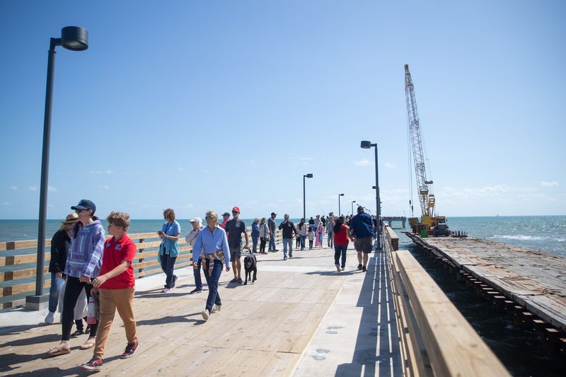 Hundreds of people enter the new Bob Hall Pier on North Padre Island in Corpus Christi on Feb. 24.