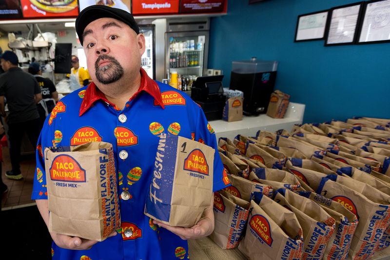 Comedian Gabriel “Fluffy” Iglesias holds bags of food at Taco Palenque, 7122 Gateway Blvd. E., Suite B, on Wednesday, Feb. 25, 2026, during a meet-and-greet at the newly opened restaurant in El Paso, Texas.