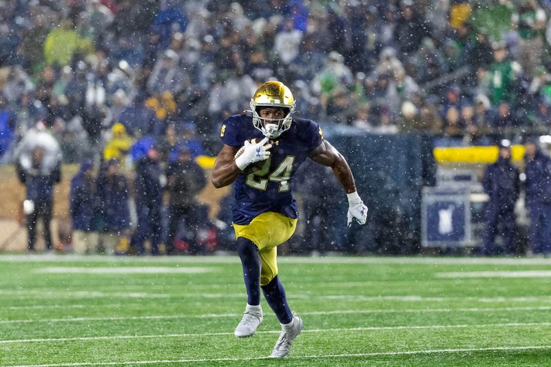 Nov 8, 2025; South Bend, Indiana, USA; Notre Dame Fighting Irish running back Jadarian Price (24) runs the ball against the Navy Midshipmen during the second half at Notre Dame Stadium. Mandatory Credit: Michael Caterina-Imagn Images