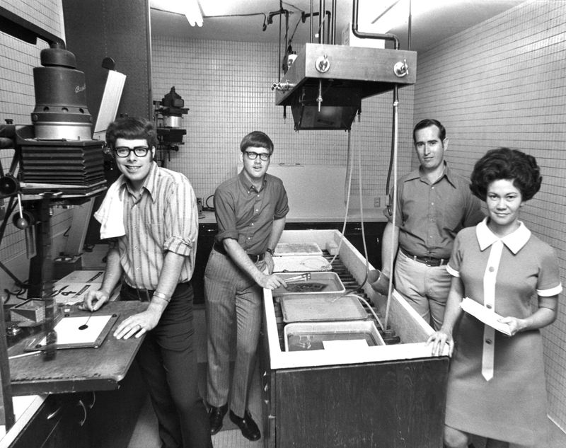 Members of the photography department at the Abilene Reporter-News are caught in action in one of the new darkrooms with modern equipment in this undated photo taken in the early 1970s. Left to right are John Best, Milton Taylor, Larry Thomas and Pat Jones