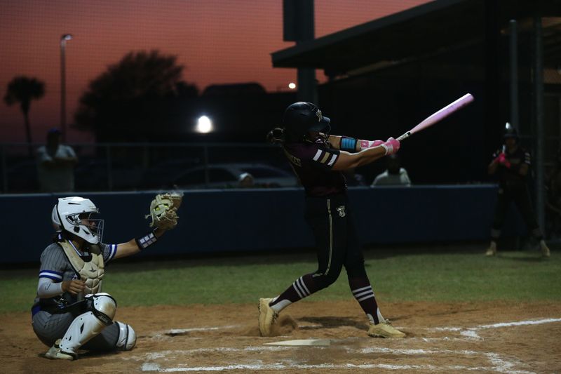 Tuloso-Midway's Avari Andrade swings through a pitch as the sun sets behind the field at Carroll High School during a tournament softball game against Santa Gertrudis Academy on Feb. 26, 2026.