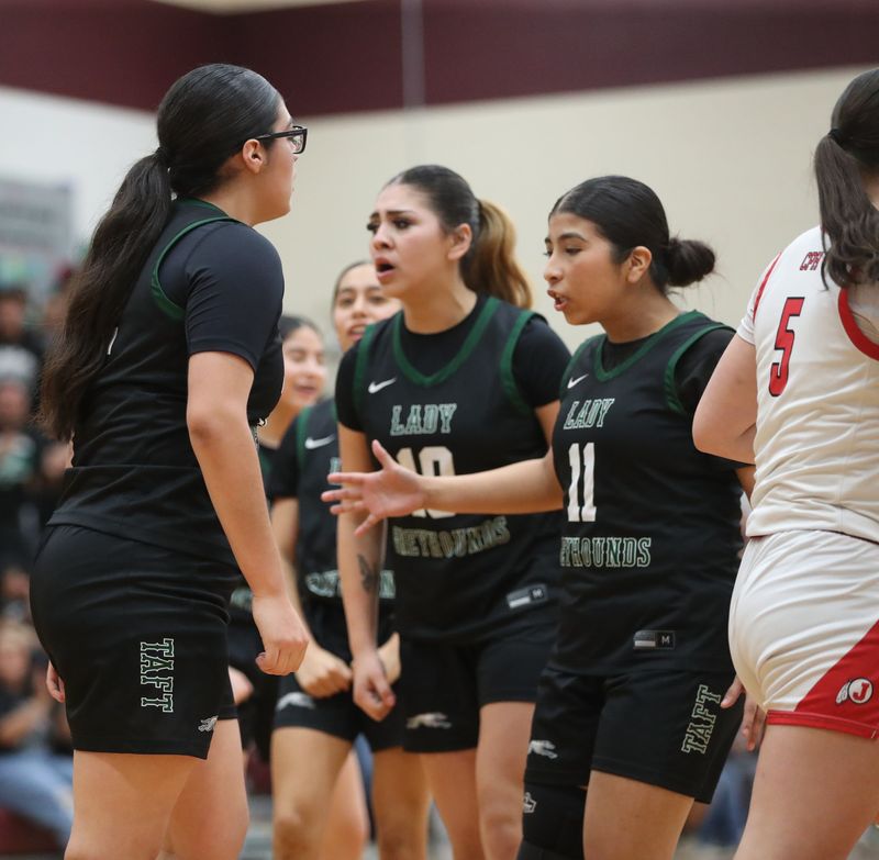 Taft's Marissa Cortez (11) and Aleinah Balderas (10) are fired up after Yaneli Rios, left, scores a basket during Friday's Class 3A Division II regional final against Jourdanton on Feb. 27, 2026 at Calallen High School.
