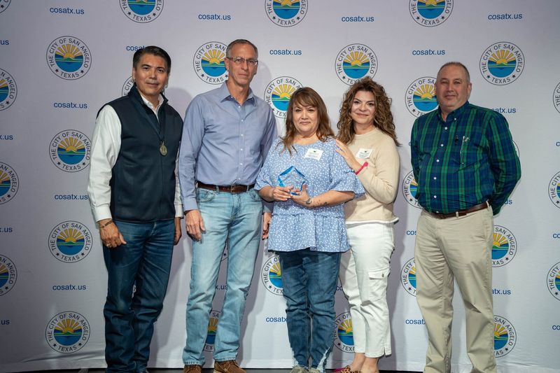 The city of San Angelo awarded the 2025 Employee of the Year award to Building Permits Clerk Annette Garza, middle, on Thursday, Feb. 19, 2026.