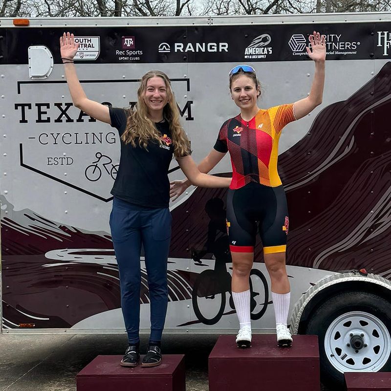 MSU Texas Cycling team members Emma Kasza-James and Gabrielle Wrightsman on the podium after a 2026 race in College Station.