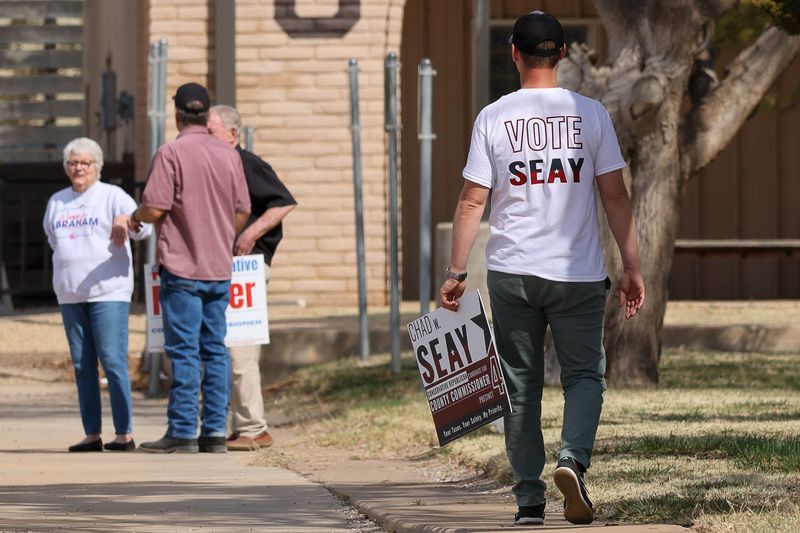 Supporters for various Lubbock County candidates campaign outside the Catholic Diocese of Lubbock, 4620 4th St., voting center on Election Day for the Texas and Lubbock County 2026 March primaries on March 3, 2026 in Lubbock, Texas.