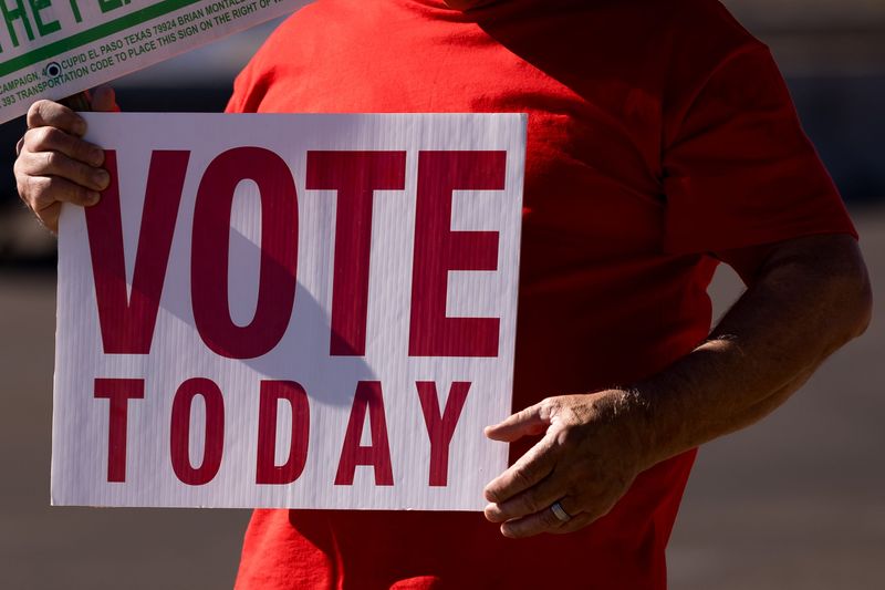 Volunteers campaign for candidates outside the Tobin Sports Center polling site during the 2026 Texas Primary Election on Tuesday, March 3, 2026, in El Paso.