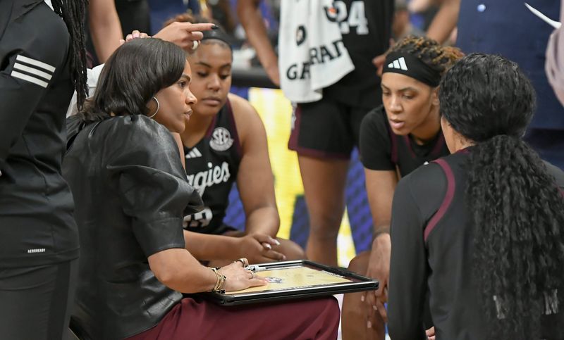 Mar 5, 2025; Greenville, South Carolina, USA; Texas A&M coach Joni Taylor talks with players during the first quarter of the Southeastern Conference Women's Basketball Tournament game with Tennessee at Bon Secours Wellness Arena.