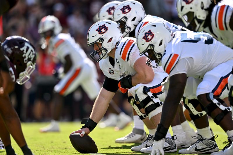 Sep 27, 2025; College Station, Texas, USA; Auburn Tigers offensive lineman Connor Lew (75) sets the ball against the Texas A&M Aggies at Kyle Field. Mandatory Credit: Maria Lysaker-Imagn Images