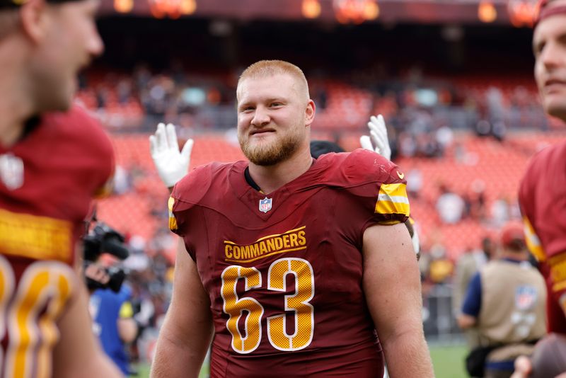 Sep 21, 2025; Landover, Maryland, USA; Washington Commanders center Tyler Biadasz (63) walks off the field after the game against the Las Vegas Raiders at Northwest Stadium. Mandatory Credit: Amber Searls-Imagn Images