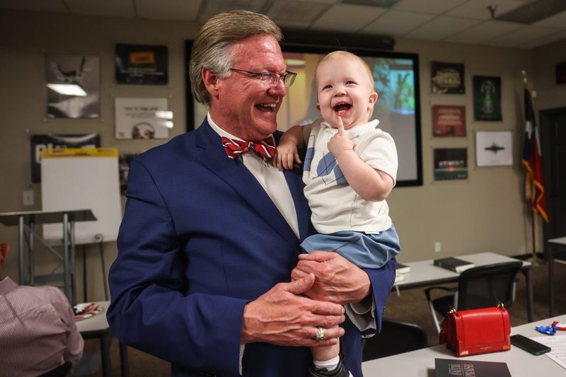 Lubbock County Judge Curtis Parrish interacts with his grandchild Brayden, during a watch party for the primary election at WestMark Realty conference center March 3, 2026, in Lubbock