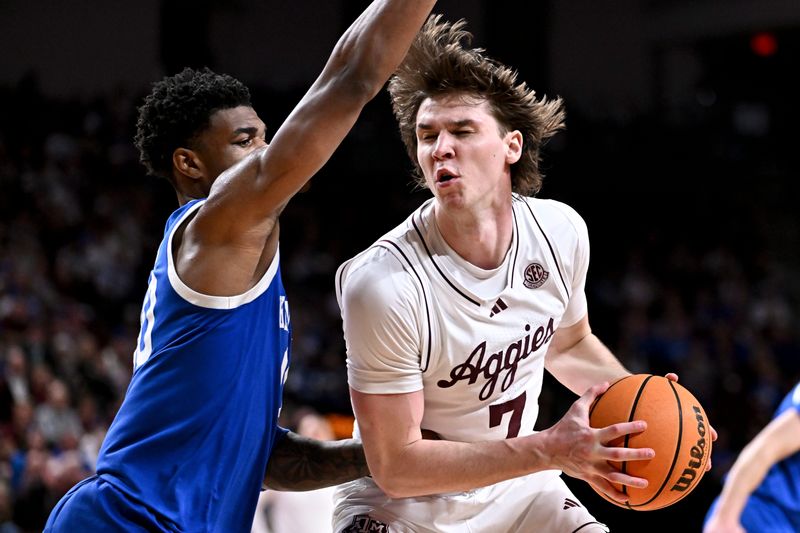 Mar 3, 2026; College Station, Texas, USA; Texas A&M Aggies forward Zach Clemence (7) drives as Kentucky Wildcats guard Otega Oweh (00) defends during the second half at Reed Arena. Mandatory Credit: Maria Lysaker-Imagn Images