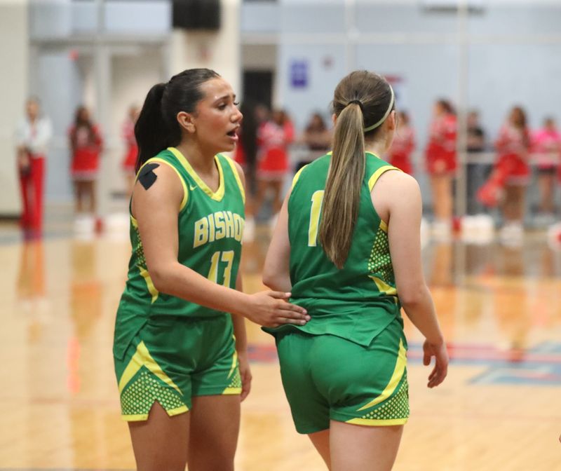 Bishop's Leah Gutierrez, left, shares a moment with Ava Salinas after Salinas scored and was fouled during Tuesday's Class 3A Division I state semifinal game against Hitchcock on March 3, 2026 at Tidehaven High School in El Maton.