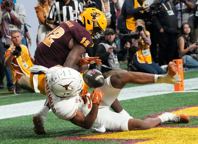 Texas defensive back Malik Muhammad (5) breaks up a pass intended for Arizona State wide receiver Malik McClain (12) in overtime in the Chick-fil-A Peach Bowl in Atlanta on Wednesday, Jan. 1, 2025.