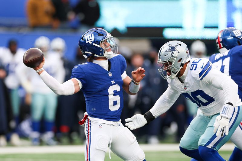 Jan 4, 2026; East Rutherford, New Jersey, USA; New York Giants quarterback Jaxson Dart (6) throws a pass as Dallas Cowboys defensive tackle Solomon Thomas (90) defends during the fourth quarter at MetLife Stadium. Mandatory Credit: Vincent Carchietta-Imagn Images
