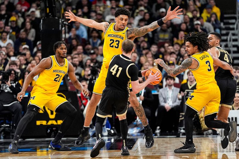 Michigan forward Yaxel Lendeborg (23) defends Purdue guard Braden Smith (41) during the second half of Big Ten Tournament final at United Center in Chicago on Sunday, March 15, 2026.