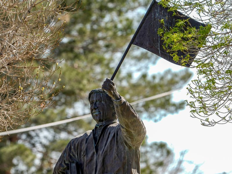A statue of late labor leader Cesar Chavez stands outside Cesar Chavez Academy in El Paso, Texas, on March 19, 2026. The statue has drawn renewed attention amid fallout from sexual abuse allegations reported this week against Chavez, a co-founder of the United Farm Workers who died in 1993, prompting calls from at least one Ysleta Independent School District trustee to rename the school, though district officials say bylaws limit when name changes can occur.